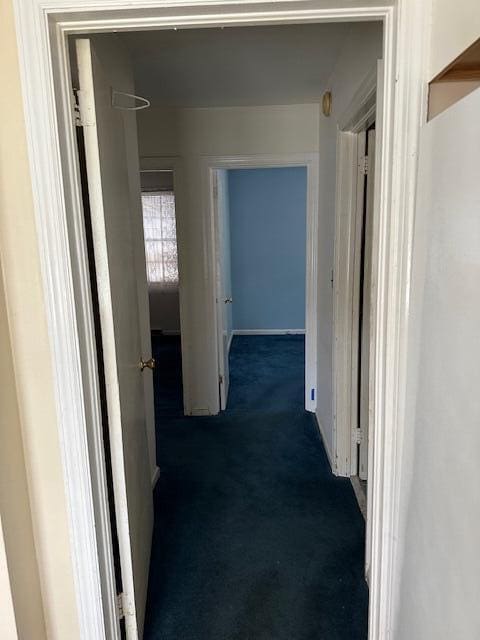 corridor with dark colored carpet