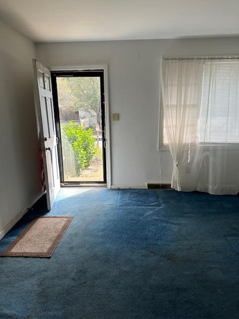 doorway to outside featuring carpet flooring