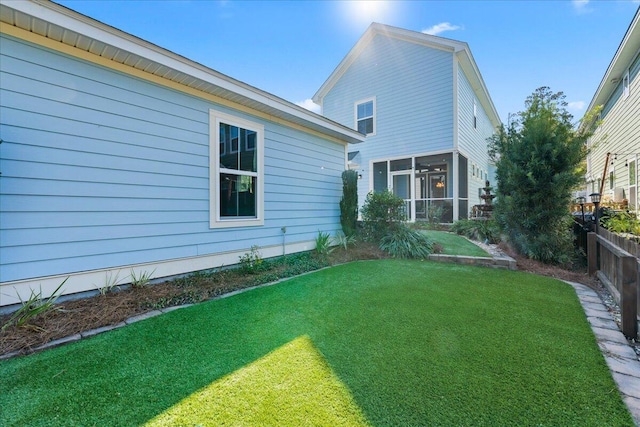 exterior space with a sunroom and a yard