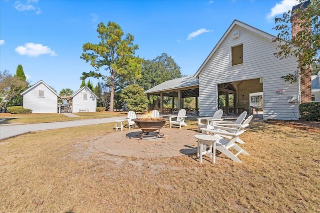 view of yard with a patio area and an outdoor fire pit