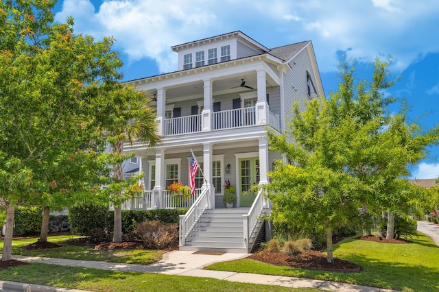 1530 Willtown St, Daniel Island, SC 29492 - greek revival inspired property with a balcony, covered porch, a ceiling fan, stairs, and a front yard