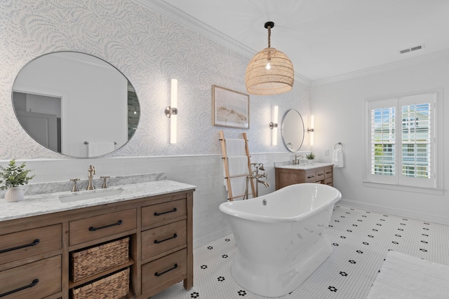1530 Willtown St, Daniel Island, SC 29492 - bathroom with vanity, a freestanding tub, crown molding, wallpapered walls, and a wainscoted wall