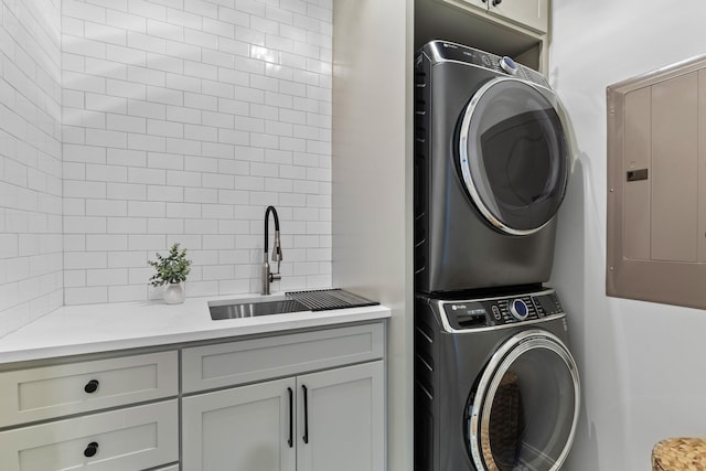 1530 Willtown St, Daniel Island, SC 29492 - laundry area with stacked washer and clothes dryer, cabinet space, and electric panel