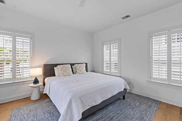 1530 Willtown St, Daniel Island, SC 29492 - bedroom with multiple windows, wood finished floors, and ceiling fan