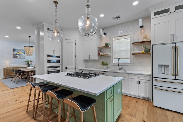 1530 Willtown St, Daniel Island, SC 29492 - kitchen with high end white refrigerator, stainless steel gas stovetop, open shelves, white cabinetry, and recessed lighting