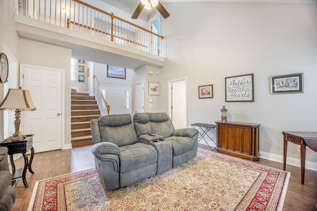 116 Holbrook Ln, Goose Creek, SC 29445 - living area featuring stairway, a high ceiling, a ceiling fan, wood finished floors, and baseboards