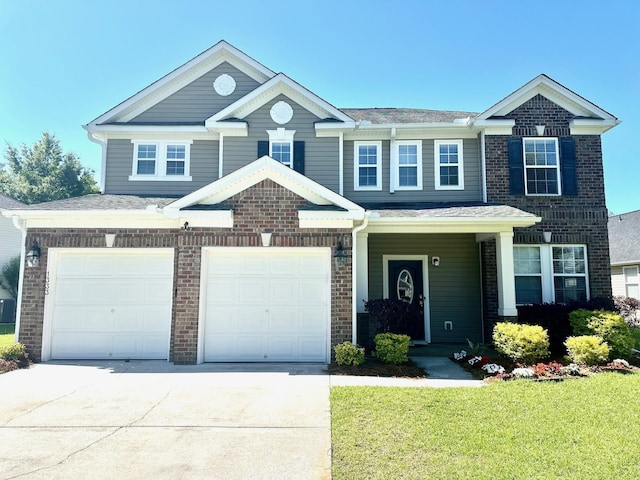 view of front of house with concrete driveway, an attached garage, brick siding, and a front yard