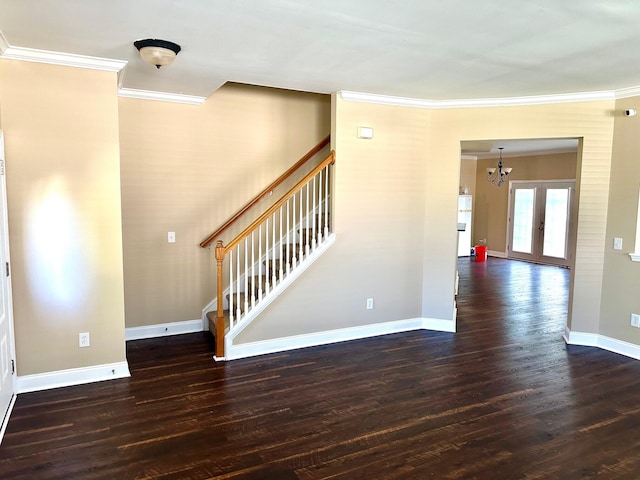 stairs with ornamental molding, a chandelier, wood finished floors, and baseboards