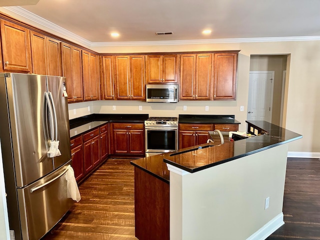 kitchen with appliances with stainless steel finishes, dark wood-style floors, crown molding, an island with sink, and brown cabinets