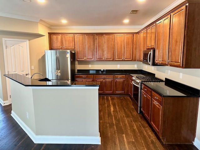 kitchen with stainless steel appliances, dark countertops, dark wood-style floors, crown molding, and brown cabinetry