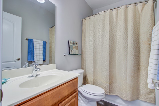 bathroom with vanity, curtained shower, and toilet