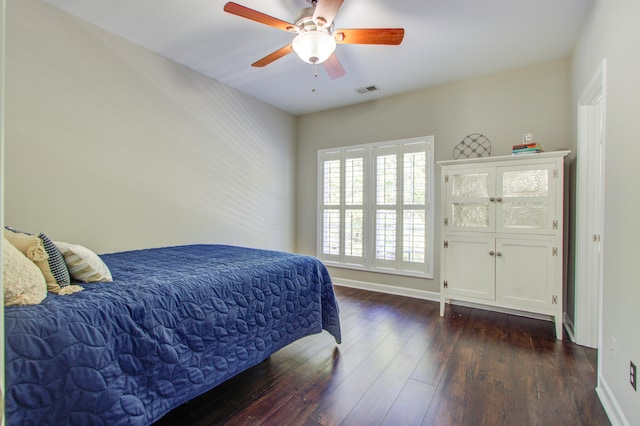 bedroom with ceiling fan and dark hardwood / wood-style floors