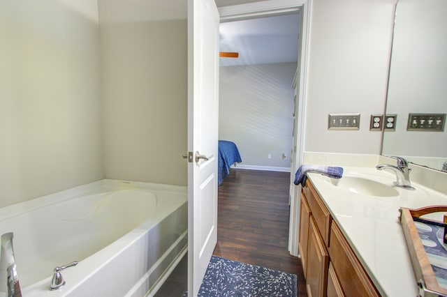 bathroom with vanity, a bathtub, and wood-type flooring