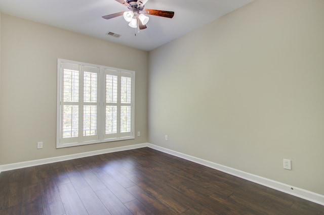 spare room featuring ceiling fan and dark wood-type flooring