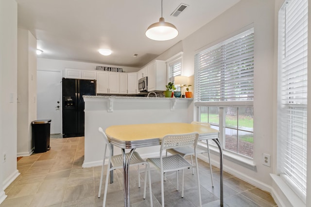 dining space featuring healthy amount of natural light, baseboards, and breakfast area