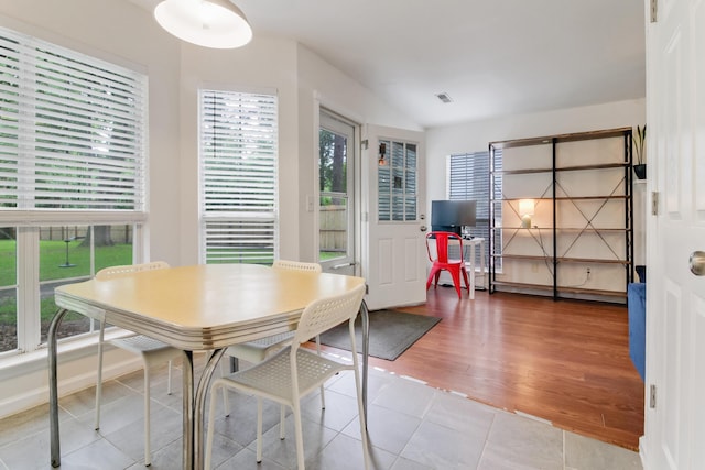 dining space featuring healthy amount of natural light and light tile patterned flooring