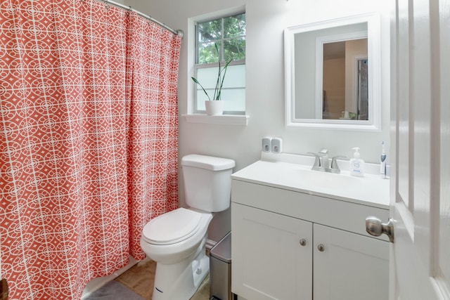 bathroom featuring toilet, vanity, and a shower with shower curtain