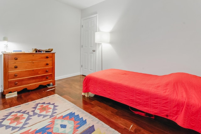 bedroom featuring wood finished floors and baseboards