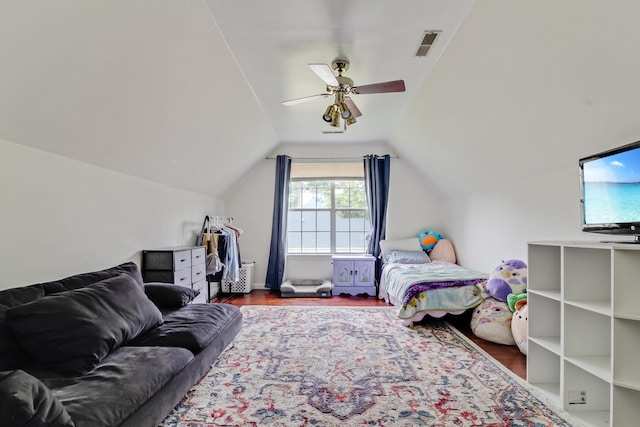 bedroom featuring wood finished floors, lofted ceiling, and a ceiling fan