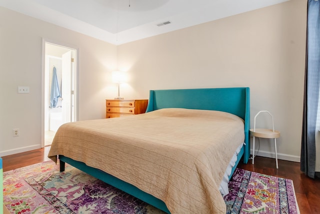 bedroom with wood finished floors and baseboards