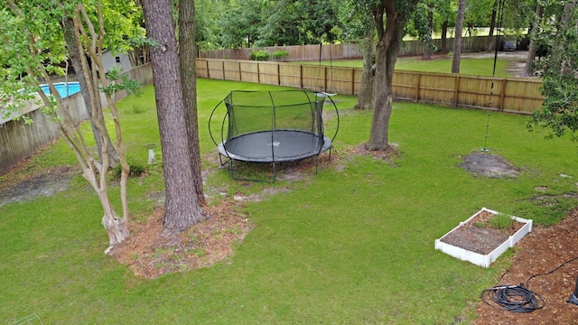 view of yard with a trampoline