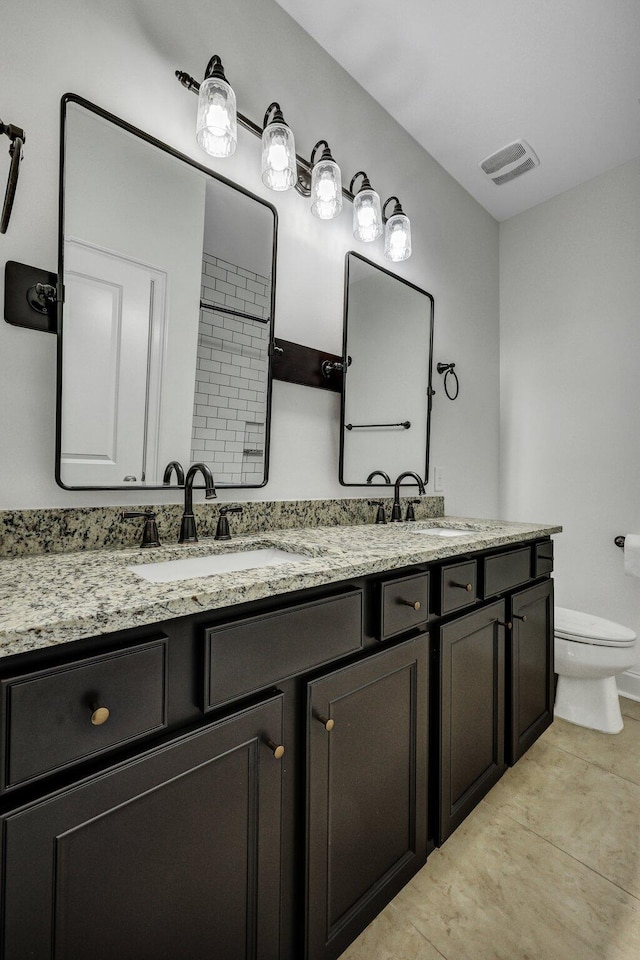 full bathroom with visible vents, a sink, toilet, and double vanity