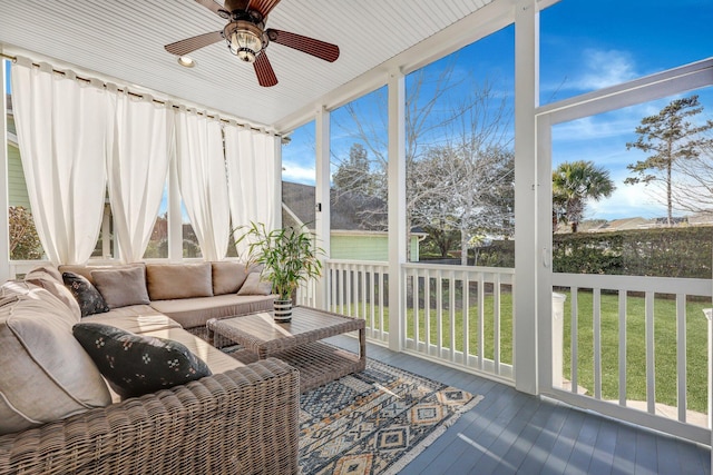 sunroom with a ceiling fan and a healthy amount of sunlight