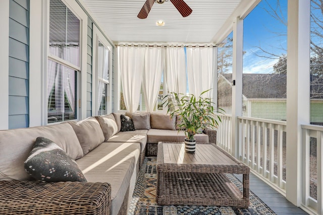 sunroom / solarium featuring a healthy amount of sunlight and ceiling fan