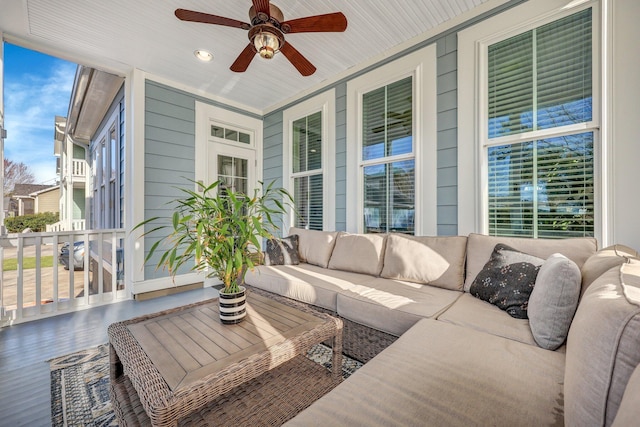 sunroom / solarium featuring ceiling fan