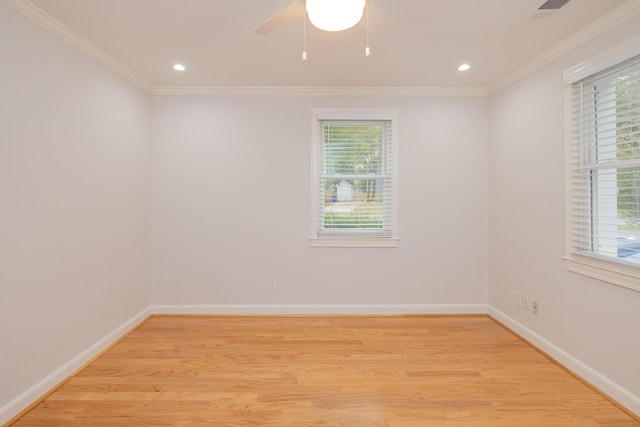 empty room featuring light wood-type flooring, ceiling fan, and crown molding