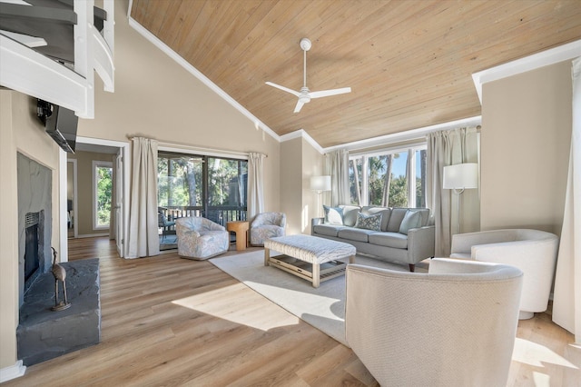 living room with light wood-type flooring, high vaulted ceiling, plenty of natural light, and ceiling fan