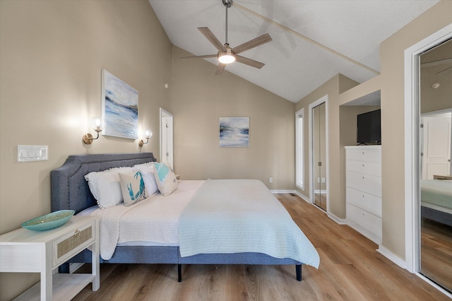 bedroom featuring light hardwood / wood-style floors, vaulted ceiling, and ceiling fan