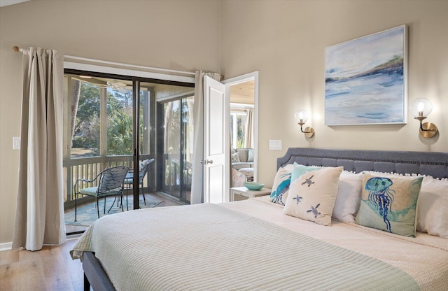 bedroom featuring light hardwood / wood-style floors and access to outside