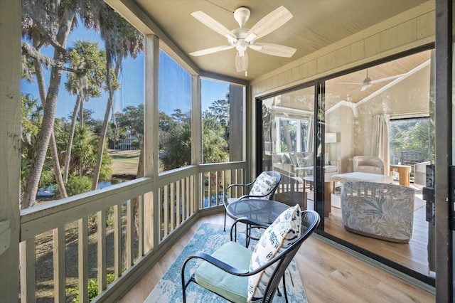 sunroom / solarium featuring ceiling fan