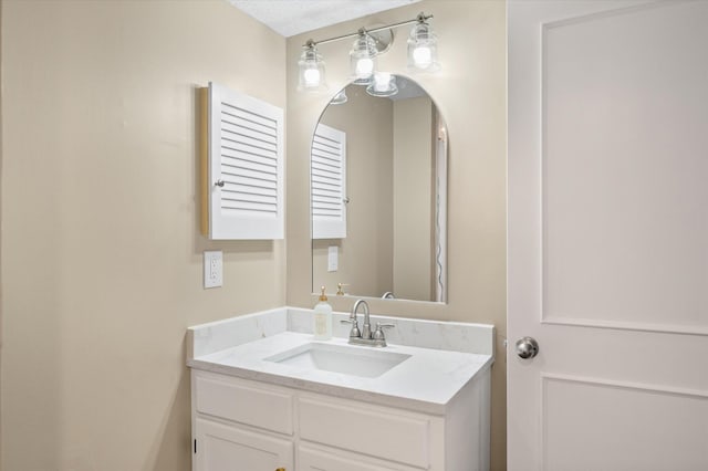 bathroom with vanity and a textured ceiling