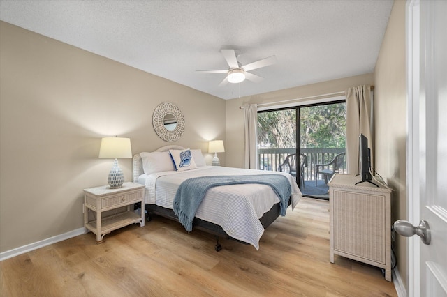 bedroom with ceiling fan, light hardwood / wood-style floors, a textured ceiling, and access to outside