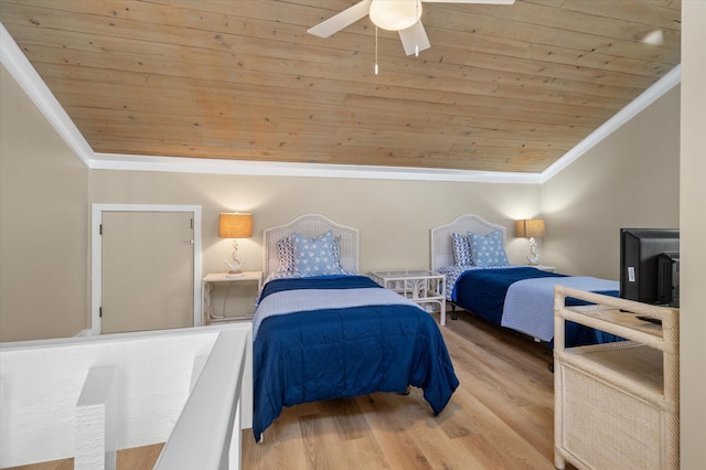 bedroom with vaulted ceiling, ceiling fan, crown molding, light hardwood / wood-style flooring, and wooden ceiling