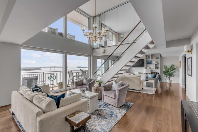330 Concord St Unit 18F, Charleston, SC 29401 - living room with stairway, a chandelier, a water view, and plenty of natural light
