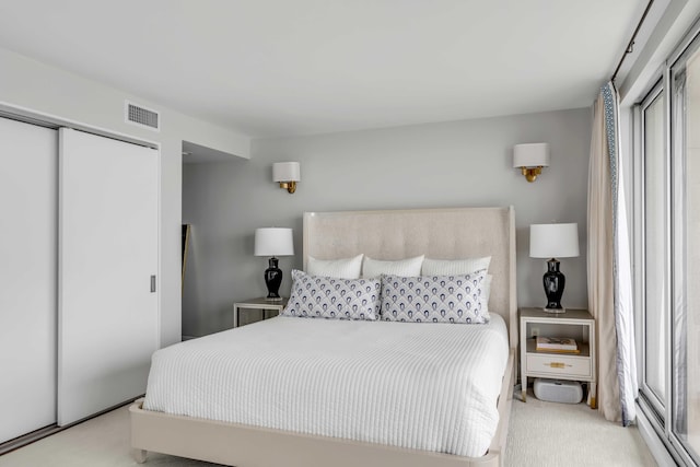 330 Concord St Unit 18F, Charleston, SC 29401 - carpeted bedroom with a closet, visible vents, and multiple windows