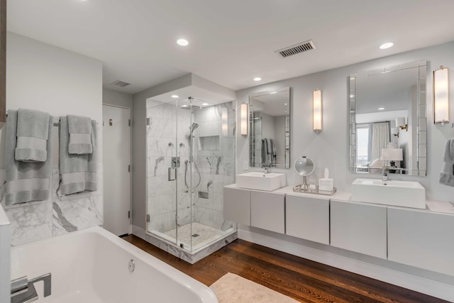 330 Concord St Unit 18F, Charleston, SC 29401 - bathroom with a stall shower, visible vents, a bath, a sink, and double vanity