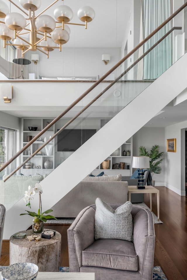 330 Concord St Unit 18F, Charleston, SC 29401 - interior space with baseboards, an inviting chandelier, a towering ceiling, and wood finished floors