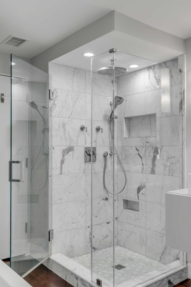 330 Concord St Unit 18F, Charleston, SC 29401 - bathroom with a marble finish shower, visible vents, and recessed lighting