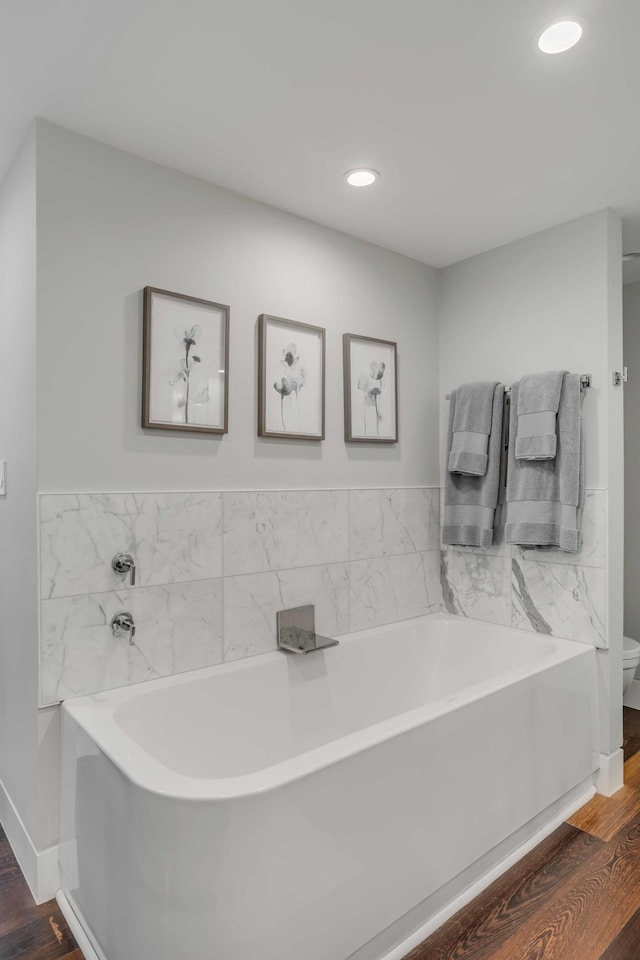 330 Concord St Unit 18F, Charleston, SC 29401 - full bath with recessed lighting, toilet, baseboards, a bath, and wood finished floors
