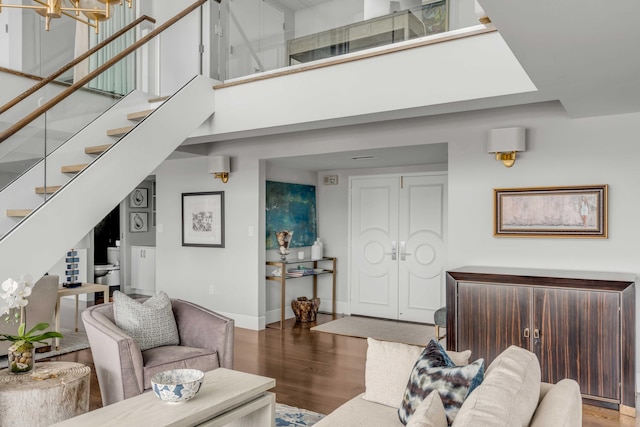 330 Concord St Unit 18F, Charleston, SC 29401 - living room with stairs, a high ceiling, baseboards, and wood finished floors
