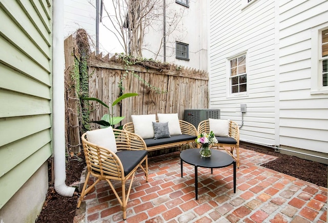 view of patio / terrace featuring cooling unit, fence, and an outdoor hangout area