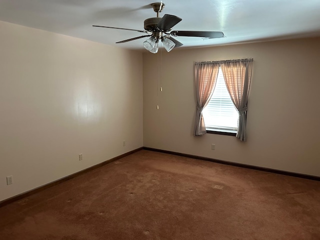 carpeted spare room with baseboards and ceiling fan