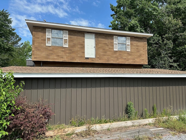 view of property exterior featuring roof with shingles