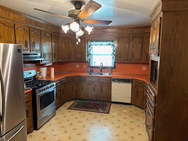 kitchen featuring a ceiling fan, light floors, a sink, exhaust hood, and stainless steel appliances