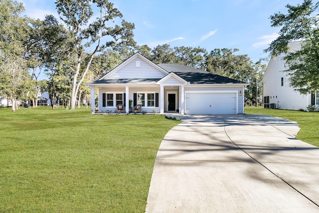 view of front of home featuring a porch, a garage, and a front lawn