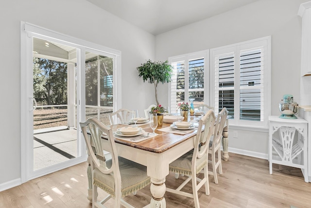 dining space with plenty of natural light and light hardwood / wood-style flooring